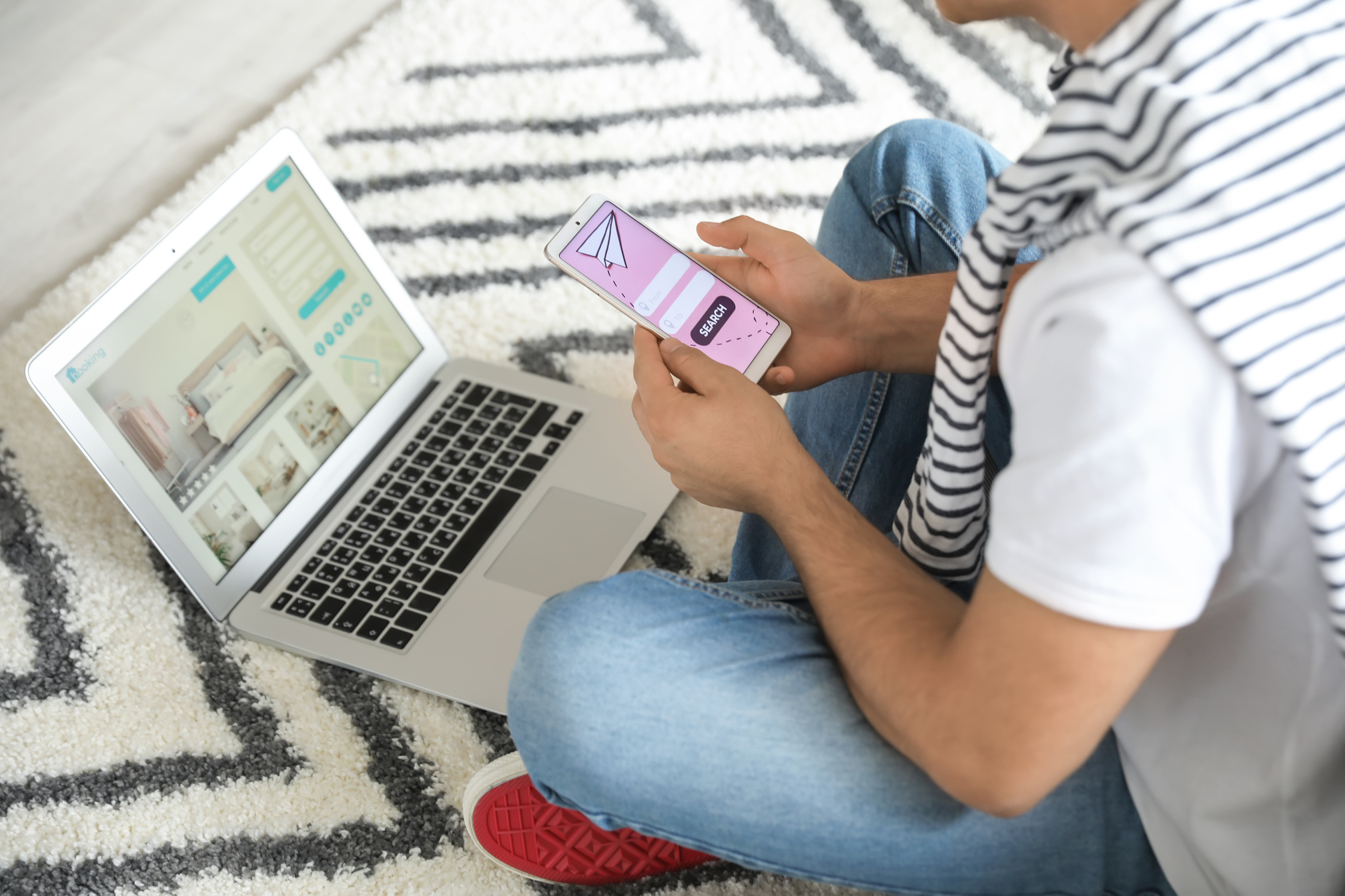 Man with Mobile Phone Booking Tickets Online at Home