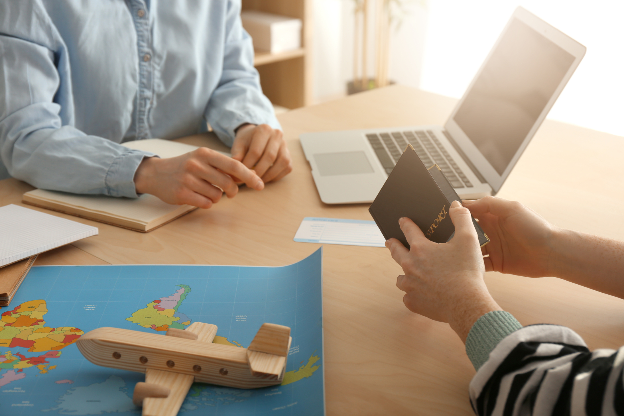 Client Discussing Tour with Travel Agent in Office